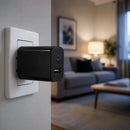 2-in-1 Adapter Spy Camera plugged into a wall outlet with a cozy living room blurred in the background