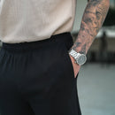 Close-up of black chinos at the elastic waistband and side pocket