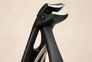 Close-up of the angled cutting head with two curved stainless steel blades.