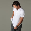 Man adjusting the hem of the white short-sleeve polo shirt