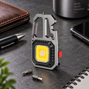 NightClip light on a workbench beside two screwdriver bits