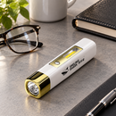 White and gold Mini Shark flashlight on a desk