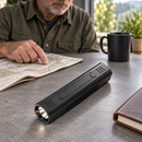 TrailCore flashlight on a table beside a map