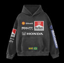 Front view of the black Senna-inspired hoodie against a dark background