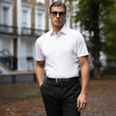 Man wearing a white semi-spread collar polo shirt outdoors