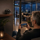 Man remotely monitoring office security at night using Nano Vision Camera and smartphone live view
