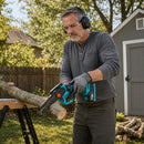 Portable mini chainsaw cutting a tree branch during outdoor pruning